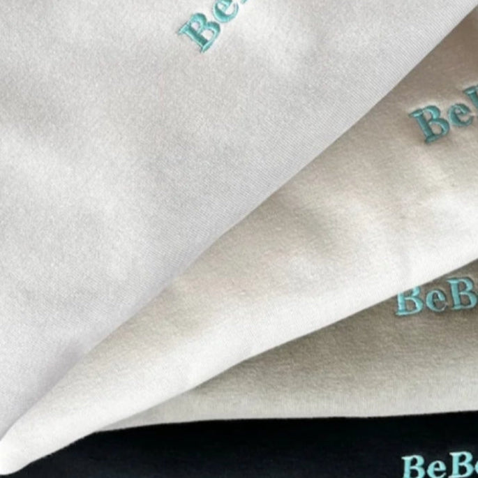 A Stack of Mens Heavy 400gsm Crew Neck  Jumpers with embroidered details on the sleeves and chest.